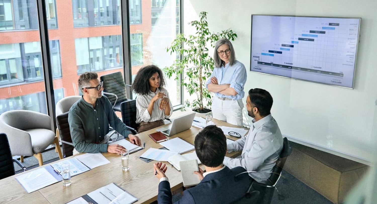 Compliance team in a meeting room reviewing a PEP screening dashboard